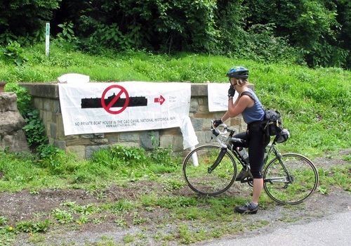 Bicyclist examines banner