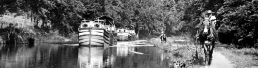 Canal boats in tow