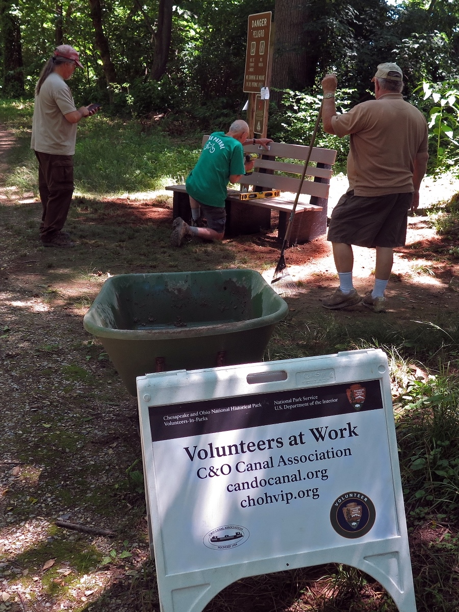 Volunteers work on bench